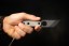 TOPS ALRT XL-03 compact fixed blade knife featuring a black utility blade with a durable angular tip and black canvas micarta handles.