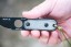 TOPS ALRT XL-05 compact fixed blade knife featuring a black hunter's point blade shape and black canvas micarta handles.